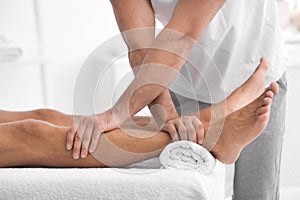 Young man receiving massage in salo