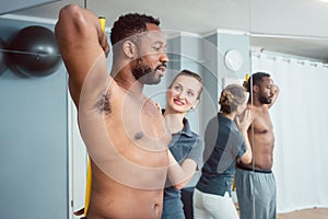 Young man receiving physical therapy on his shoulder