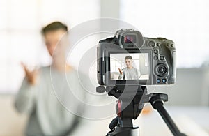Young man recording video for an internet reportage or tutorial streaming