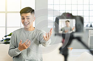 Young man recording video for an internet reportage or tutorial streaming