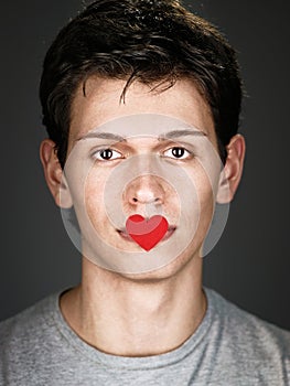 Young man with red heart