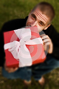 Young man with a red present