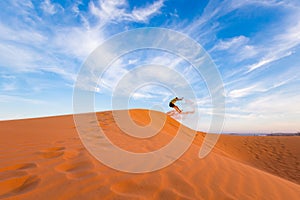 Young man on Red sand dunes in Vietnam