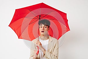 A young man red umbrella a man in a light jacket  background unaltered
