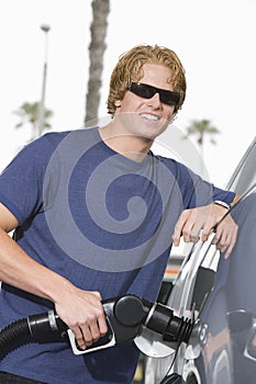 Young Man Refueling His Car