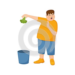 Young man refuse eating broccoli and throws it in trash can. Guy with refusing gesture, facial expression of disgust