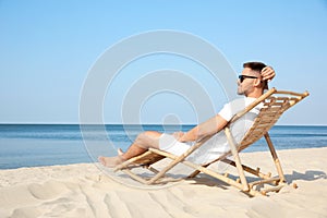 Young man relaxing in deck chair