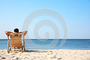 Young man relaxing in deck chair