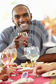 Young Man Relaxing At Dinner Party