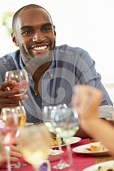 Young Man Relaxing At Dinner Party