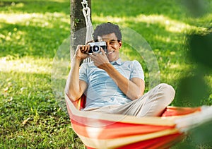 Young man relaxing on hammock in park
