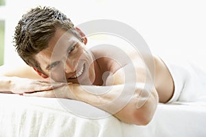 Young Man Relaxing On Massage Table