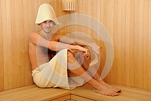 Young man relaxing in a russian wooden sauna