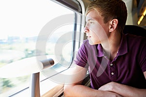 Young Man Relaxing On Train Journey