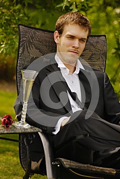 Young man relaxing in tuxedo