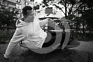 Young Man Reliving His Childhood Plying In A Children`s Playground