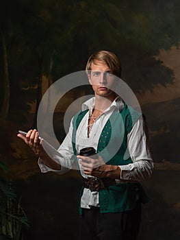 Young man in Renaissance style uses gadgets.