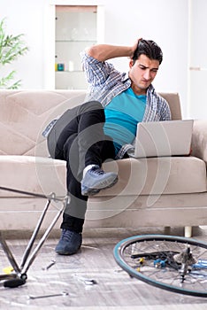 The young man repairing bicycle at home