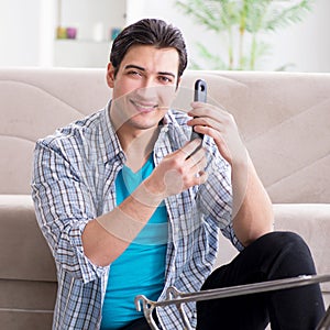 Young man repairing bicycle at home