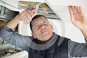 young man repairing ceiling photo