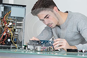 Young man repairing computer