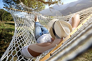 Young man resting in hammock outdoors on sunny day