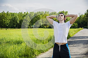 Young man resting standing in middle of the road