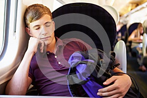 Young Man Resting On Train Journey