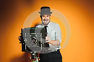 Young man with retro camera