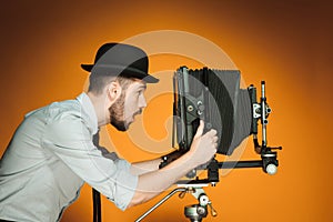 Young man with retro camera