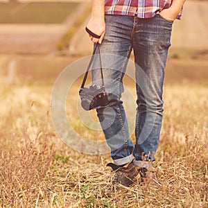 Young Man with retro photo camera outdoor hipster Lifestyle