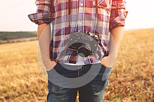 Young Man with retro photo camera outdoor hipster Lifestyle