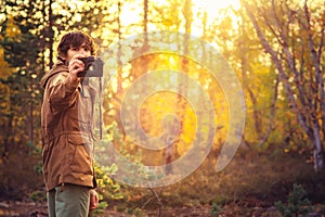 Young Man with retro photo camera outdoor hipster Lifestyle