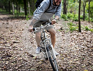 Young man ride mountain bike in the forest