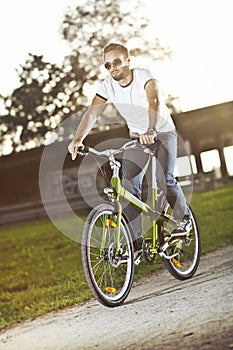 Young man riding bicycle