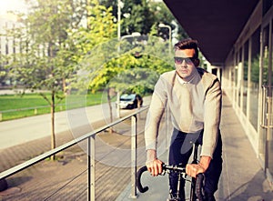 Young man riding bicycle on city street