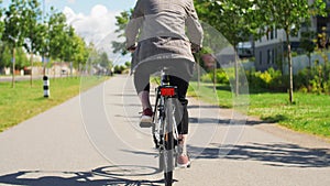 Young man riding bicycle on city street