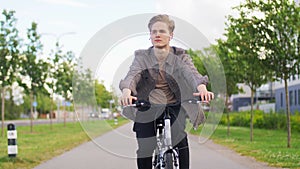 Young man riding bicycle on city street