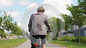 Young man riding bicycle on city street