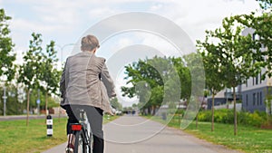 Young man riding bicycle on city street