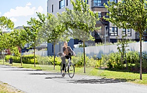 Young man riding bicycle on city street