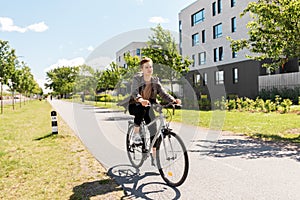 Young man riding bicycle on city street