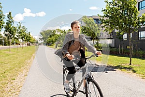 Young man riding bicycle on city street