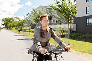 Young man riding bicycle on city street