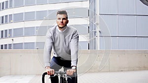 Young man riding bicycle on city street