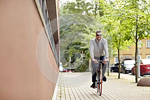 Young man riding bicycle on city street