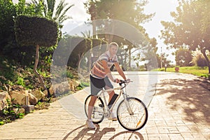 A young man riding a bicycle in a park