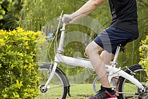 Young man riding on the bicycle on the pathway.