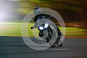 Young man riding big bike motorcycle on asphalt high way against