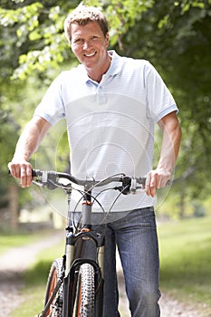 Young man riding bike in countryside